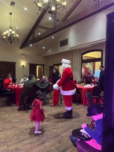 Santa Claus making a surprise visit at the Felix And Fingers event at Cathedral Oaks